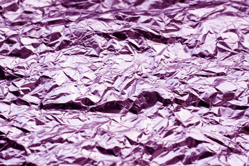 Metal foil texture in purple tone.