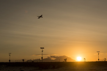 Fototapeta na wymiar Silhouette takeoff plane from the airport while sunset