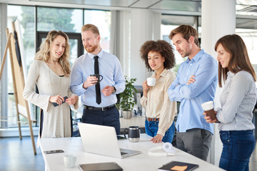Small group of business people standing at office and solving problem at meeting. Multi cultural group.