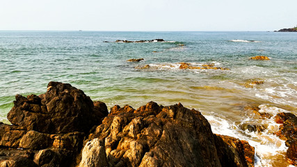Sea surf, rocks and white foam.