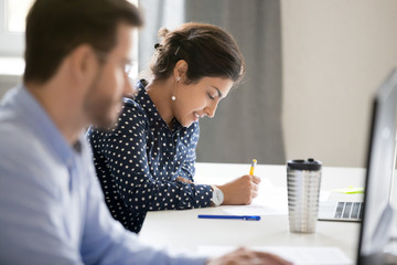 Happy mother receiving gift and bouquet from daughter and grandmother