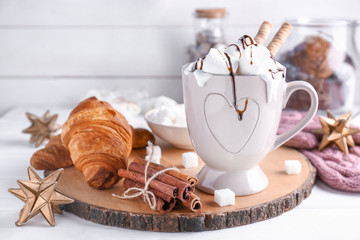 Cup with tasty coffee on table