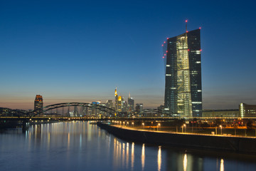 Naklejka premium Frankfurt European Central Bank Tower in front of the skyline at river Main at blue hour