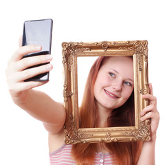 young woman taking selfie with picture frame with camera phone
