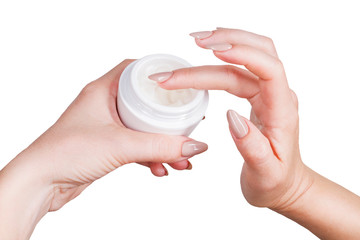 female hands are gaining cream from a jar