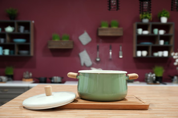 Saucepan on table in modern kitchen