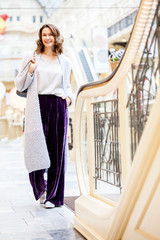 smiling beautiful woman in a light knitted coat