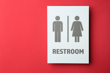 Unisex restroom sign board on color background. Concept of transgender