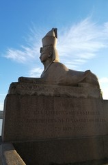 A stone Sphinx on a blue sky background