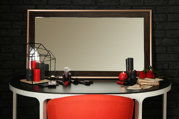 Set of cosmetics and big mirror on dressing table