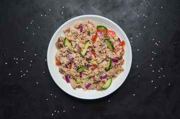 Thai Tuna Salad on the black table. Top view. 