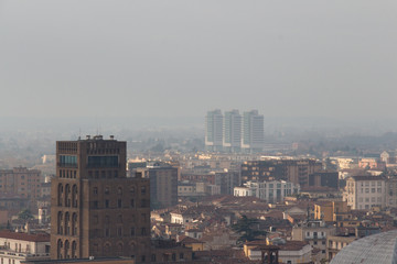 Brescia cityscape, buildings in fog, Lombardy, Italy.