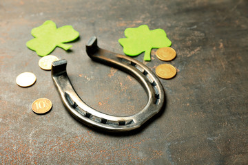 Composition with horseshoe, coins and clover for St. Patrick's Day on grey background