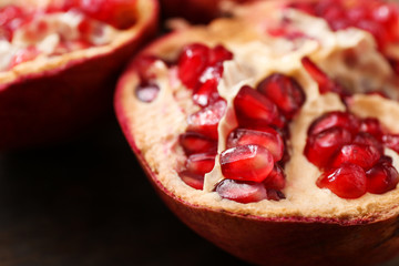 Ripe pomegranate on wooden table, closeup