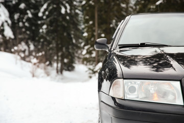 Fototapeta na wymiar Car on road at snowy winter resort