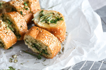 Tasty cut garlic bread on table