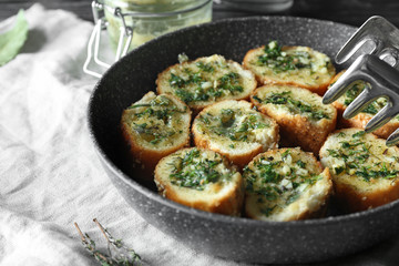 Tasty cut garlic bread in frying pan
