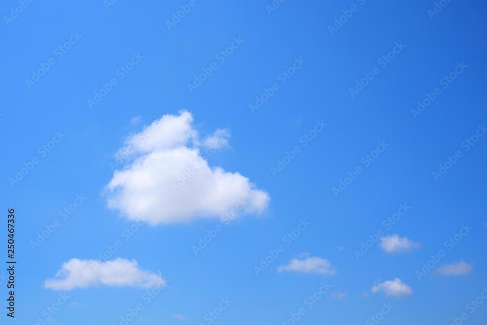 Wall mural white cumulus clouds on blue sky background in clear sky concept