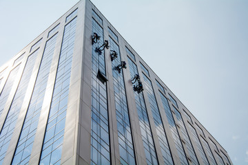 Male worker in overalls professional glass cleaner washer