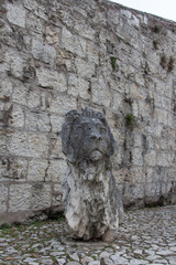 Fototapeta na wymiar An ancient lion sculpture in the Castle of Brescia, Lombardy, Italy.