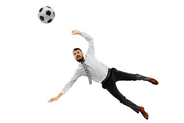Fototapeta premium Full length shot of a young businessman playing football isolated on white background.