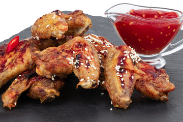 Baked chicken wings with sesame and sauce. Food background