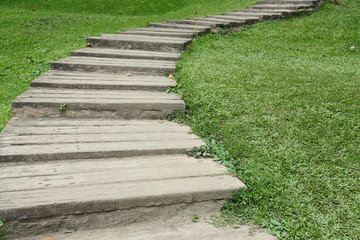 Fototapeta na wymiar garden path walkway on green grass turf