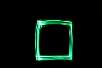 Long exposure, light painting photography.  Abstract box outline design, vibrant color against a black background