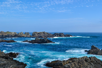 Sea cliffs in blue waters of the Pacific ocean