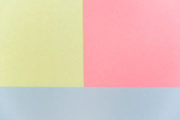 Blue, pink and yellow pastel color paper geometric flat lay background