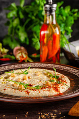 The concept of Arabic cuisine. Oriental hummus with grilled sesame and pistachios. Laid arabic table for the holiday. Background image. Top view, copy space