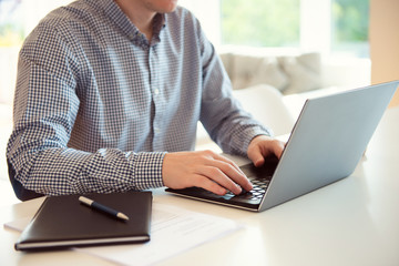 Closeup photo of man working with laptop