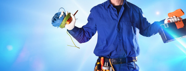 Uniformed electrician with tools and equipment with effect of lights