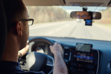 Cautious driver is moving along the highway. Safe and rational driving.  Insight view.