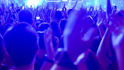 abstract colorful background audience in public concert.
