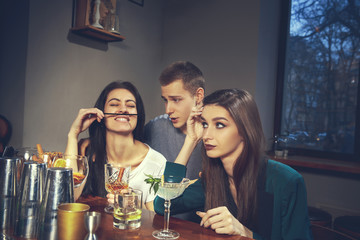 Photo of joyful friends in the bar or at pub communicating with each other