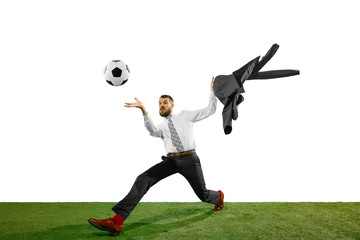Naklejka premium Full length shot of a young businessman playing football isolated on white background.
