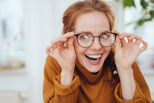 Surprised girl touching glasses
