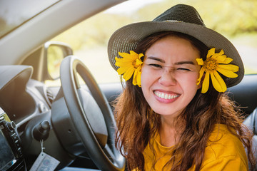 Asian women are on vacation. Drive happily traveling to the Mexican sunflower flower garden in Thailand.