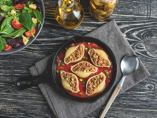 cooked pasta conchiglioni stuffed minced meat, tomato sauce