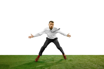Fototapeta na wymiar Full length shot of a young businessman playing football isolated on white background.