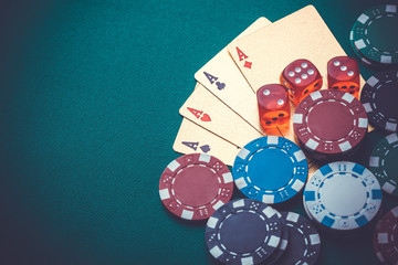 playing cards, chips, dice, on a green table. Casino concept