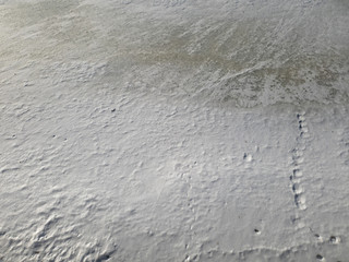 Snow on the ice of the river. Frozen river. Ice on the river.