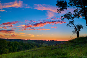 Obraz na płótnie Canvas Sunset Over an Open Field