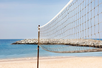 Beach volleyball net on sunny day at seaside