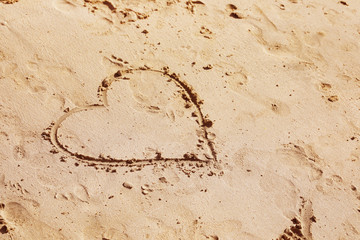 Drawing of heart on sandy surface, space for text