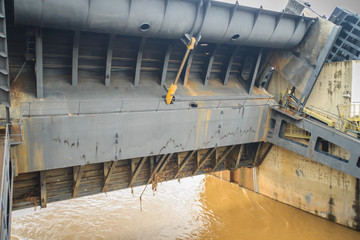 Hydraulic water gate is shifting up to allow water flow through in the rainy season. The Pak Mun Dam is run-of-the-river hydroelectric plant of the Mun river in Ubon Ratchathani Province, Thailand.