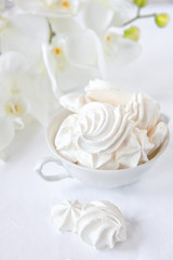 Fototapeta na wymiar Meringues. Protein sugar cake for tea or coffee. Light background.White morning. Candy