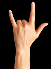 Female hand showing rock n roll sign or giving the devil horns gesture