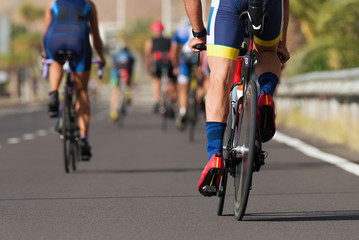 Naklejka na ściany i meble Cycling competition cyclist athletes riding a race at high speed